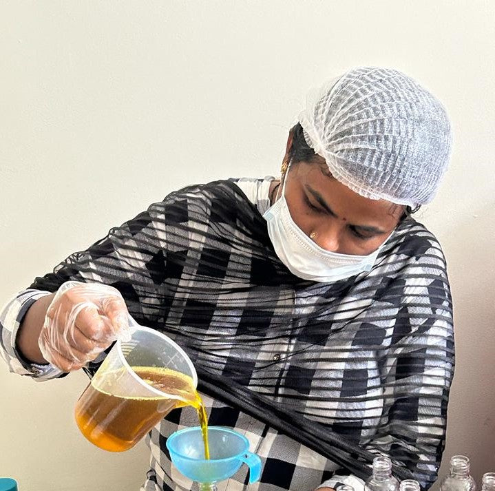 a female pouring liquid formula into container