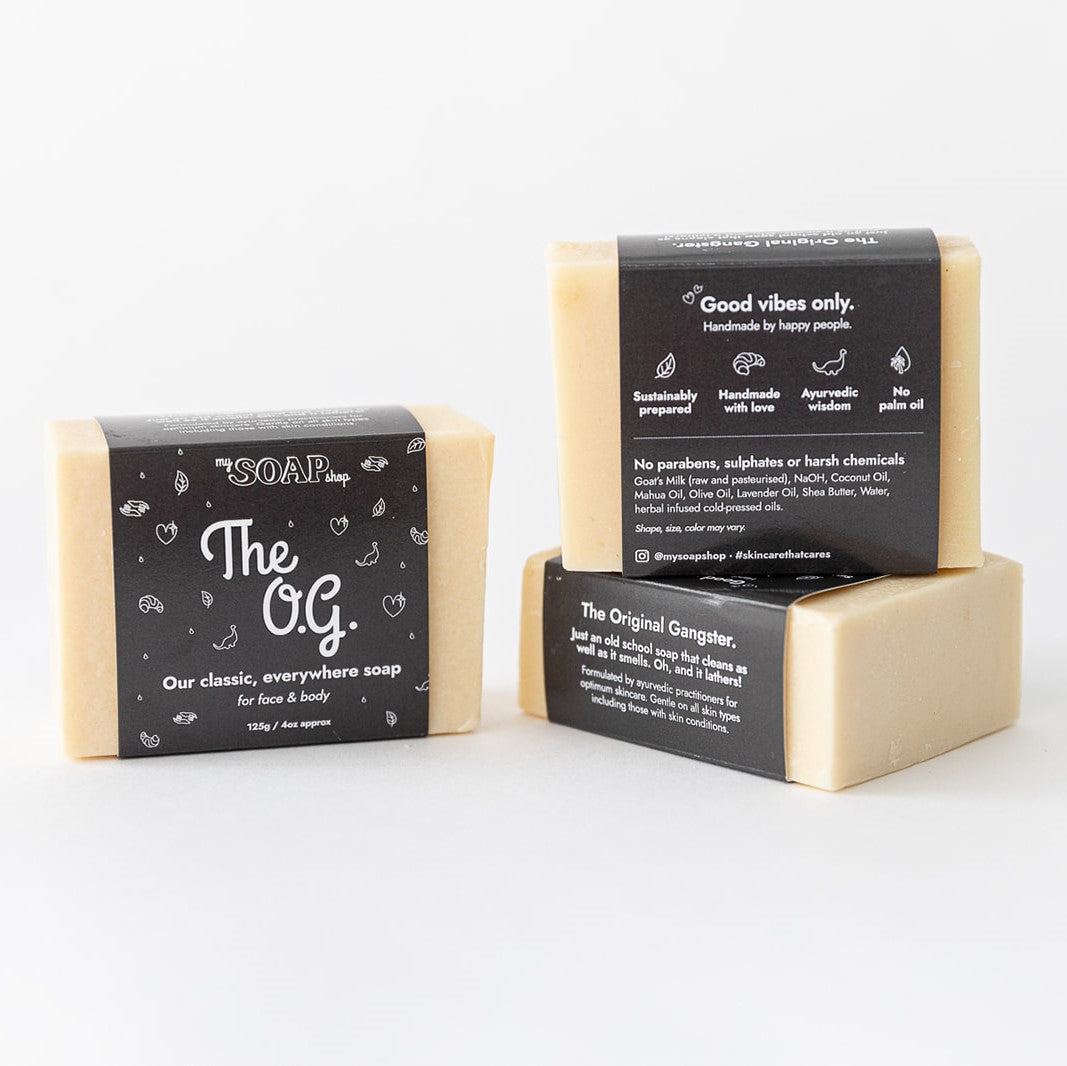 3 bars of The OG face and body soap showing all sides of quirky packaging.